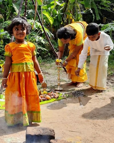 Mother with two kids in the fields in India
